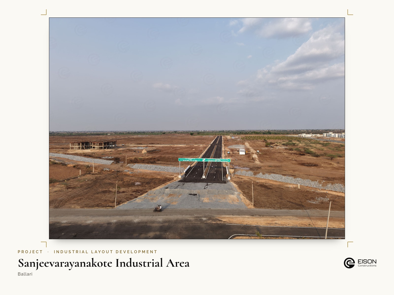 Sanjeevarayanakote Industrial Area, Ballari: internal road with a green sign gantry across open industrial land