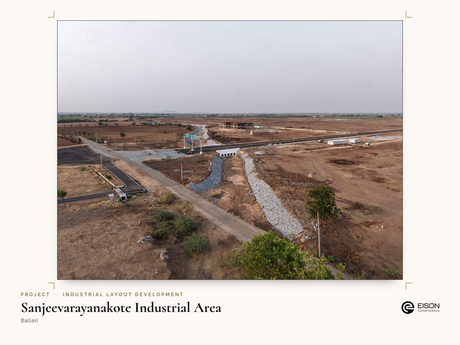 Sanjeevarayanakote Industrial Area, Ballari: stone-pitched storm-water drain and culvert beside the road