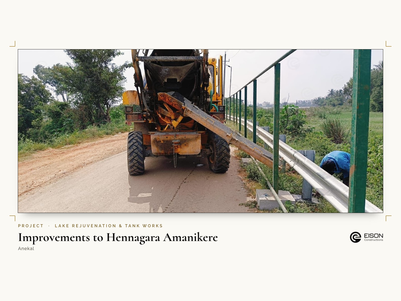 Improvements to Hennagara Amanikere, Anekal: concrete mixer working beside the new fencing and guard rail